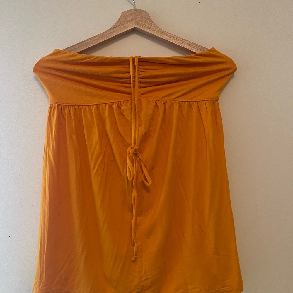 Yellowish-orange strapless stretchy female blouse